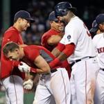 Stephen Drew (center) celebrated with David Ortiz, Shane Victorino, and other teammates after Drew’s 15th-inning single won the game for the Red Sox.